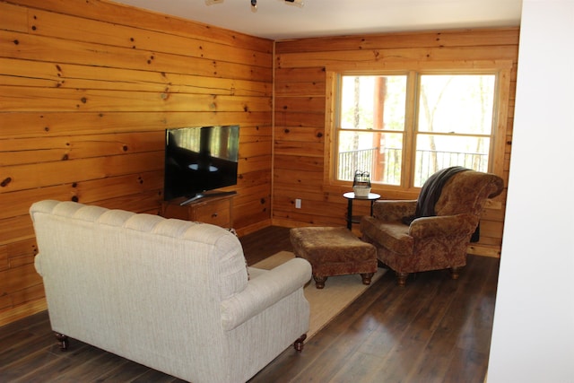 living room with wooden walls and dark hardwood / wood-style flooring