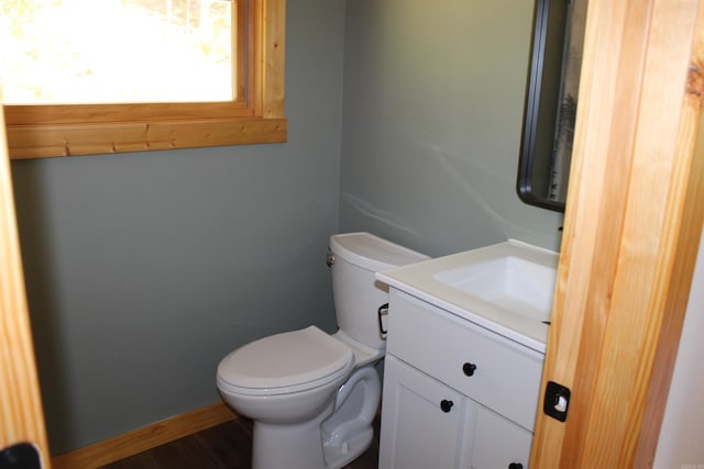 bathroom featuring wood-type flooring, vanity, and toilet