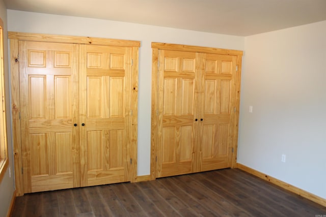 unfurnished bedroom with dark hardwood / wood-style flooring