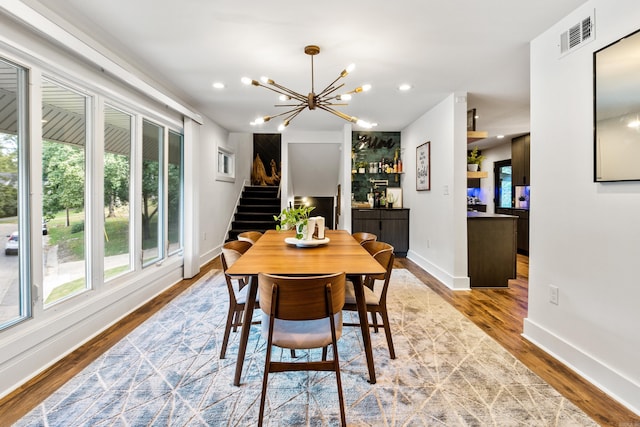 dining room with wood-type flooring and a chandelier