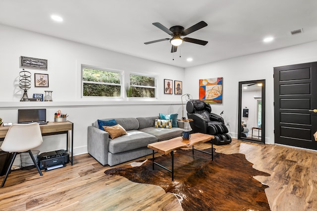 living room featuring light hardwood / wood-style floors and ceiling fan