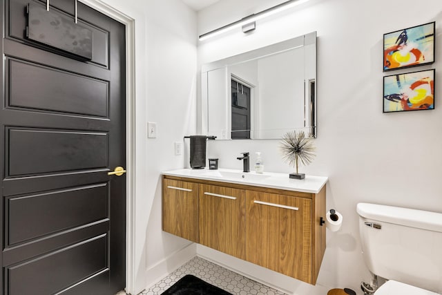 bathroom with vanity, tile patterned flooring, and toilet