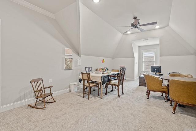 carpeted dining area with ornamental molding, vaulted ceiling, and ceiling fan