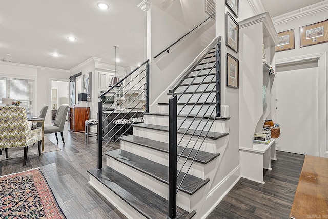 stairway with ornamental molding and wood-type flooring