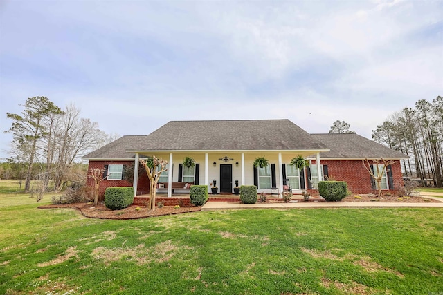 view of front of property with a front lawn, a porch, and brick siding