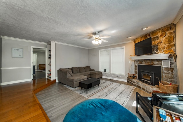 living room featuring ornamental molding, ceiling fan, a textured ceiling, and hardwood / wood-style floors