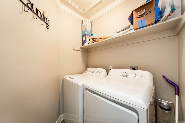 clothes washing area featuring separate washer and dryer and crown molding