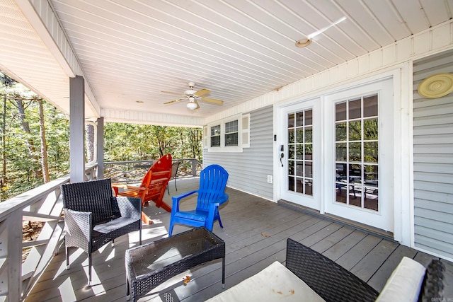 deck featuring an outdoor living space, ceiling fan, and french doors