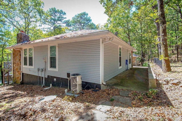 view of side of home featuring central air condition unit