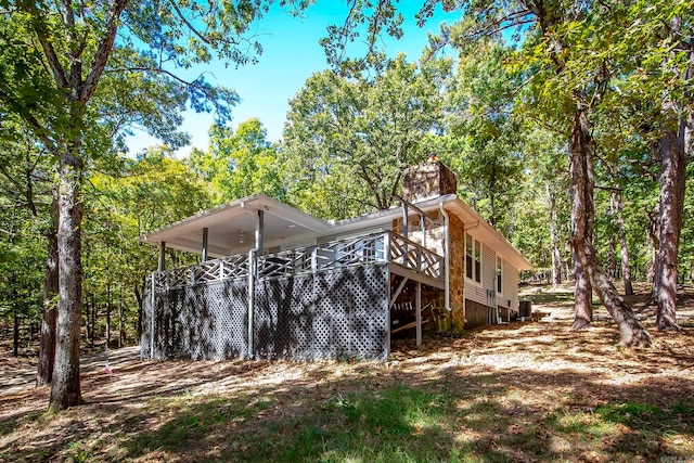 rear view of house with a wooden deck