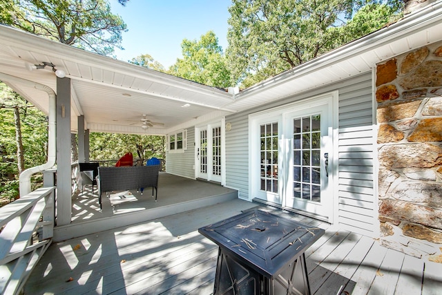 wooden deck featuring french doors and ceiling fan