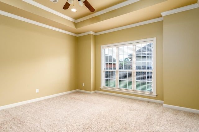 carpeted spare room featuring ceiling fan, a raised ceiling, and crown molding