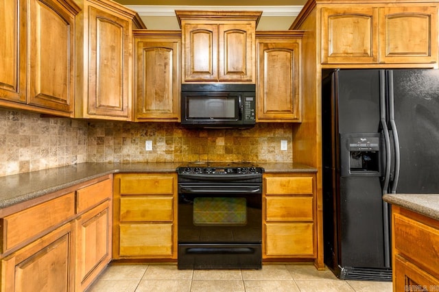 kitchen featuring ornamental molding, backsplash, light tile patterned floors, and black appliances