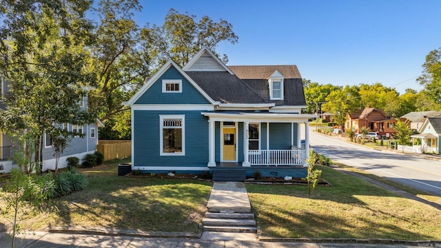 view of front of house with covered porch and a front yard