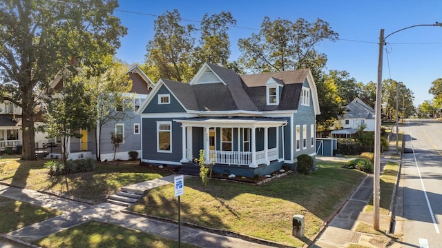 view of front facade with a front yard and a porch