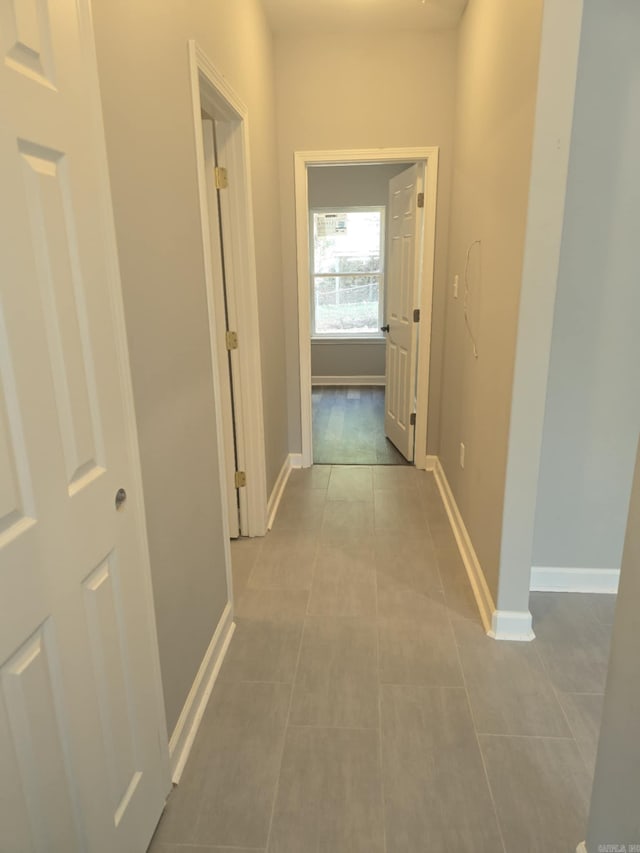 corridor with light tile patterned floors