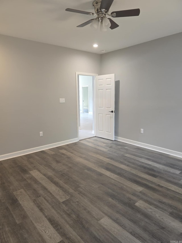 unfurnished room with ceiling fan and dark hardwood / wood-style flooring