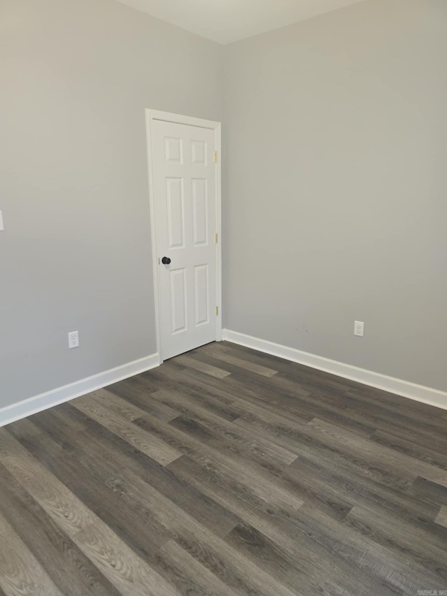 unfurnished room featuring dark hardwood / wood-style flooring