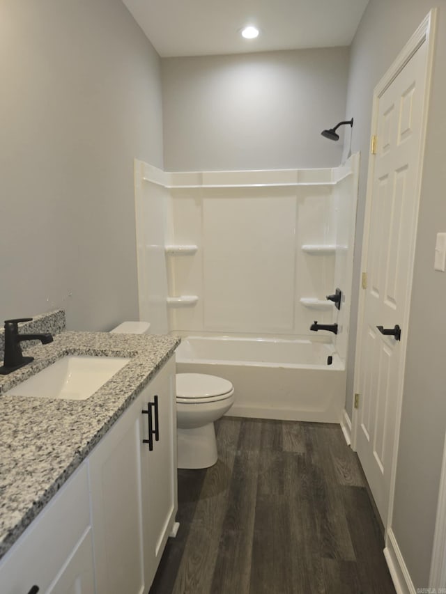 full bathroom featuring toilet, vanity, shower / bathtub combination, and hardwood / wood-style flooring