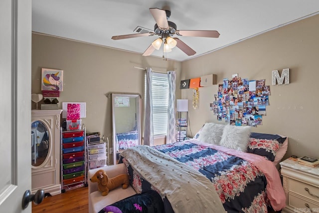 bedroom with ornamental molding, wood-type flooring, and ceiling fan