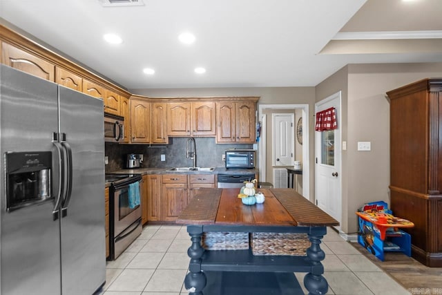 kitchen featuring backsplash, light wood-type flooring, black appliances, and sink