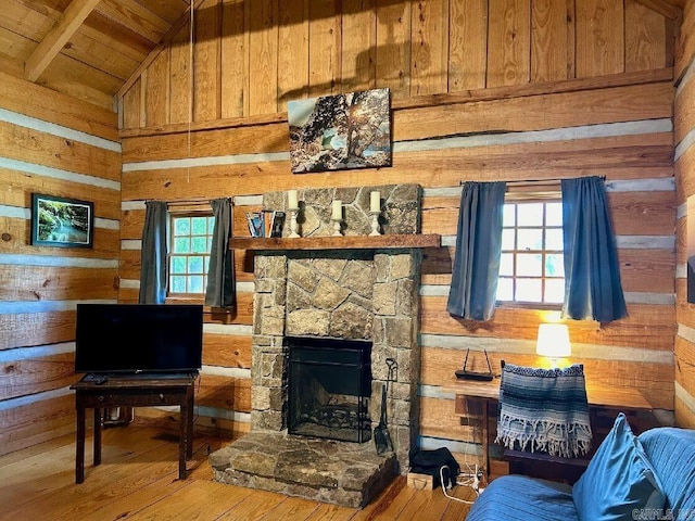 living room with wood ceiling, a fireplace, beamed ceiling, wood-type flooring, and wooden walls