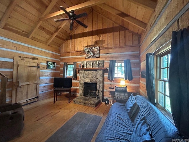 living room featuring wood walls, lofted ceiling with beams, hardwood / wood-style floors, and wooden ceiling