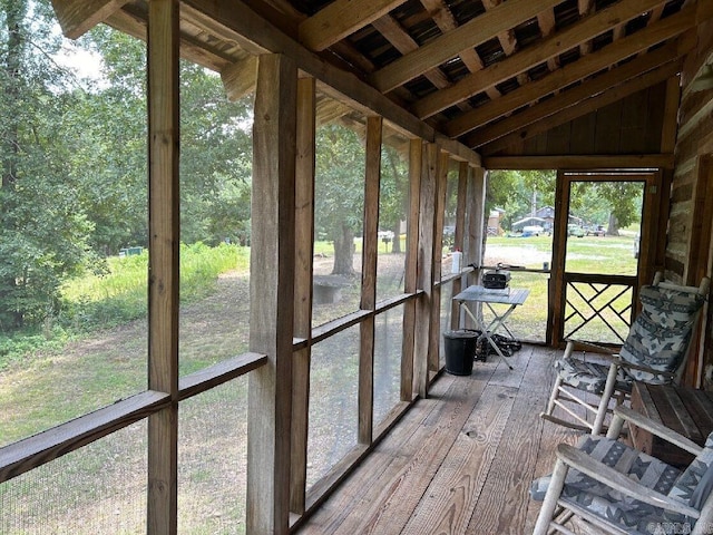 unfurnished sunroom with lofted ceiling and a healthy amount of sunlight