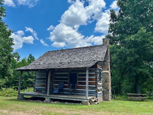 exterior space with an outbuilding, a yard, and a deck