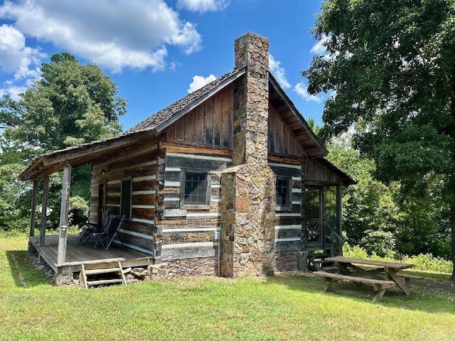 view of side of home with a lawn