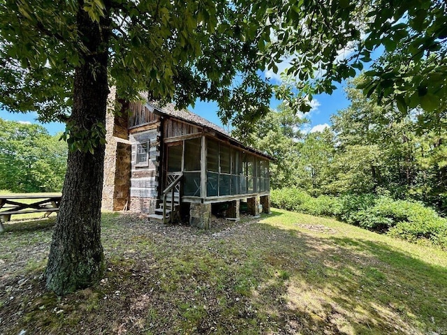 view of side of property featuring a sunroom