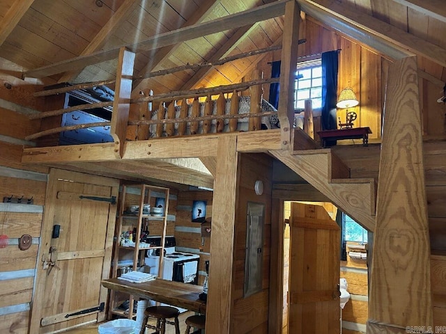 interior space featuring wooden ceiling, wooden walls, and lofted ceiling with beams