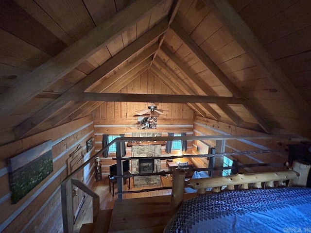 bedroom featuring wood-type flooring, vaulted ceiling with beams, wood walls, and wooden ceiling