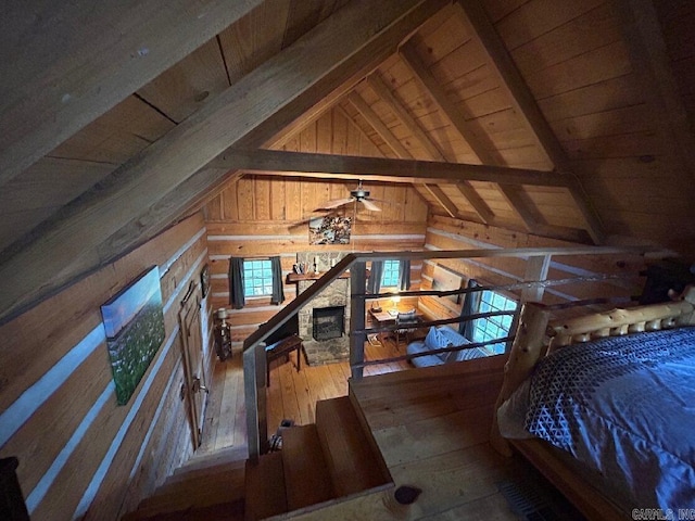 bedroom with wood-type flooring, vaulted ceiling with beams, wood walls, and wooden ceiling