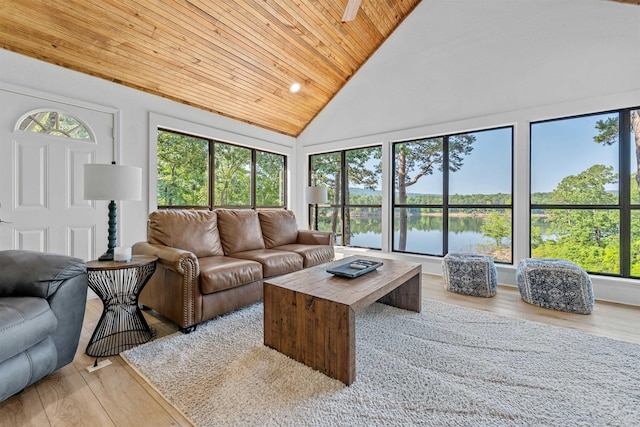 living room featuring wood ceiling, light wood-type flooring, a water view, and high vaulted ceiling