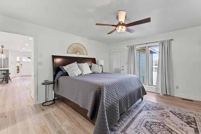 bedroom with light hardwood / wood-style floors and ceiling fan