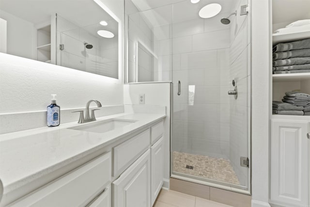 bathroom featuring vanity, tile patterned floors, and an enclosed shower