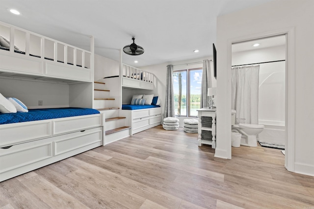 bedroom with light hardwood / wood-style flooring and connected bathroom