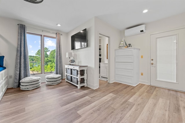 entryway with light hardwood / wood-style floors and a wall mounted air conditioner