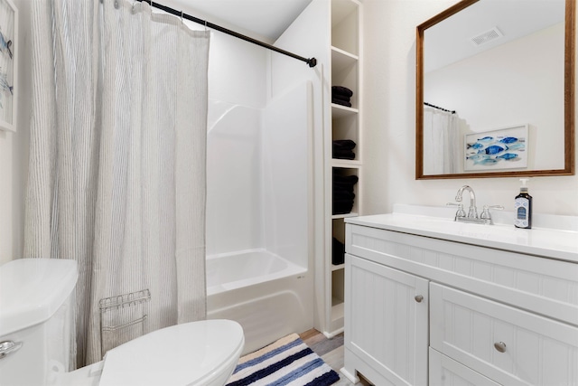 full bathroom featuring shower / bath combo, hardwood / wood-style floors, vanity, and toilet