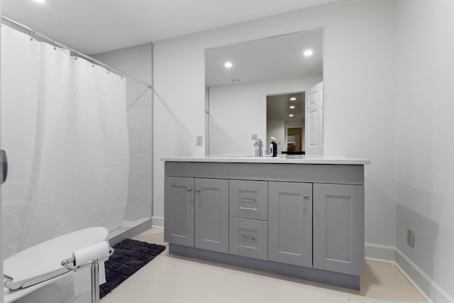 bathroom featuring vanity, toilet, and a shower with shower curtain