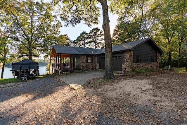 view of front facade featuring a garage and a water view