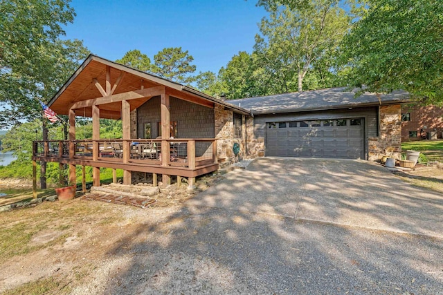 view of front of home featuring a wooden deck and a garage