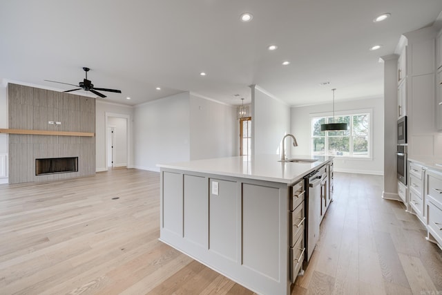 kitchen featuring a spacious island, sink, white cabinets, and stainless steel appliances