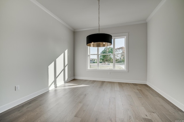 unfurnished dining area with crown molding and light hardwood / wood-style floors