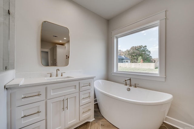 bathroom featuring vanity and a tub to relax in