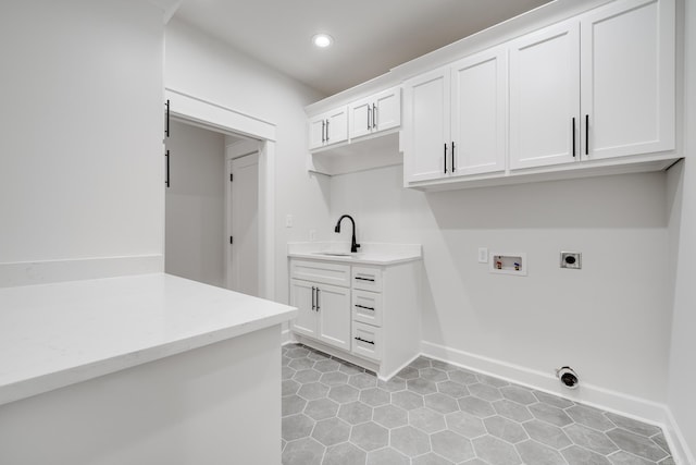 washroom with washer hookup, hookup for an electric dryer, sink, light tile patterned flooring, and cabinets