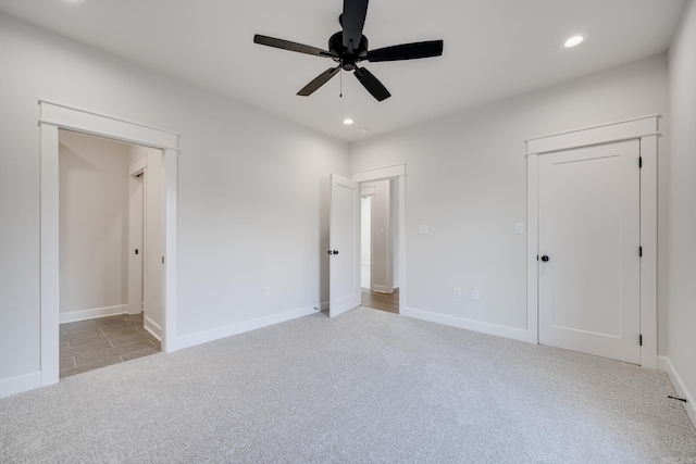 unfurnished bedroom featuring light carpet and ceiling fan