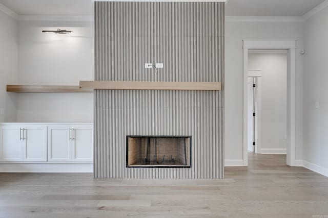 room details with crown molding, a fireplace, and hardwood / wood-style floors