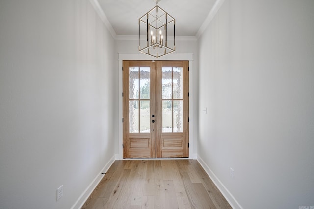 doorway to outside featuring light hardwood / wood-style floors, french doors, a notable chandelier, and crown molding